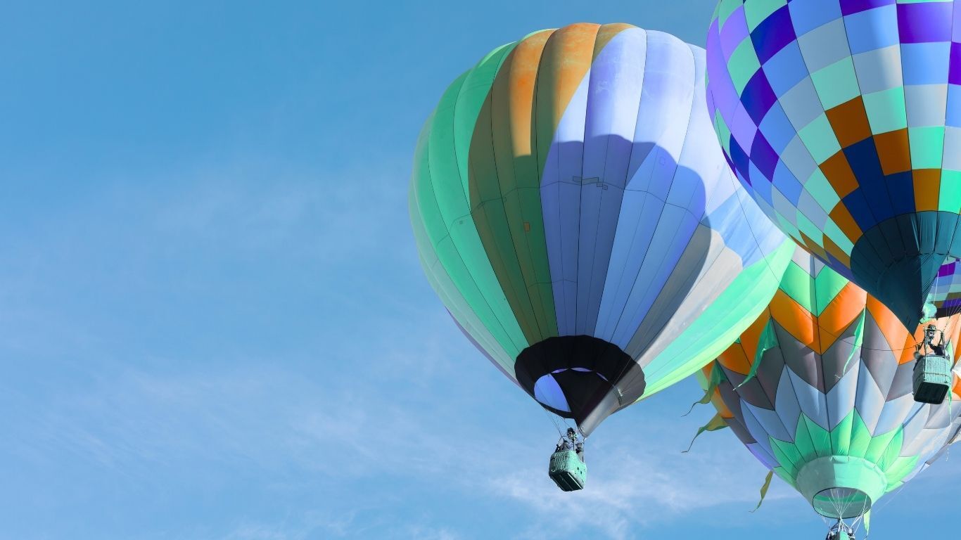 Colorful hot air balloons rising into the sky, symbolizing growth, elevation, and new opportunities.